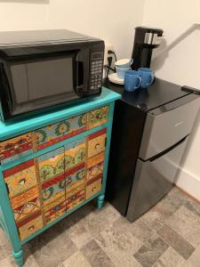 a microwave sitting on top of a dresser at Pope House - Hist. Mansion - The Wild(e) Suite in Helena