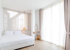 Postel nebo postele na pokoji v ubytování Haksabai Hotel Chiangrai โรงแรมฮักสบาย เชียงราย