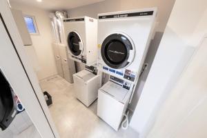 a laundry room with a washer and dryer at JL HOUSE Kutchan in Kutchan