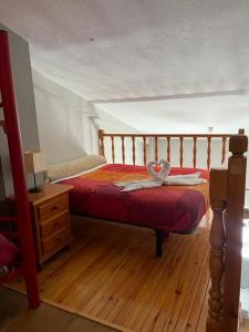 a bedroom with a bed and a wooden floor at GINEBRA SKY in Sierra Nevada