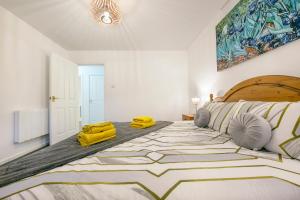 a large bedroom with a large bed with yellow cushions at Castle Terrace - Grampian Lettings Ltd in Aberdeen