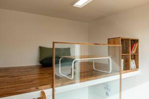 a glass shelf with a table in a room at Tamnaneun Farm in Jeju