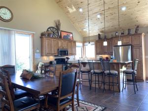 a kitchen with wooden cabinets and a wooden table with chairs at Pine Ridge Paradise in Red Lodge