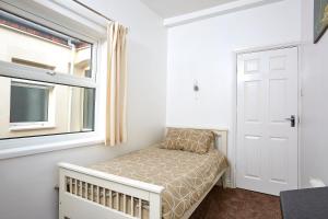 a small bedroom with a bed and a window at ire House Eire House in Coventry