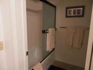 a bathroom with a tub and a shower with towels at Rr-interlaken 29 in June Lake +6 photos