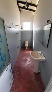 a bathroom with a sink and a toilet in it at Muru's Place in Dickwella