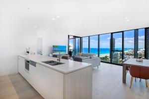 a kitchen and living room with a view of the ocean at Signature Broadbeach Ocean Views Apartment in Gold Coast