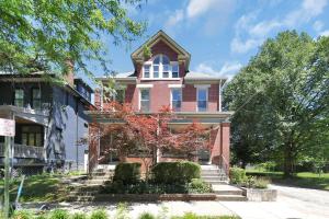 a large red brick house with a tower at Modern European 1BR near DT-Historic St in Columbus