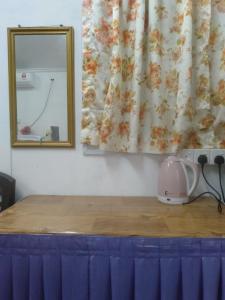 a mirror on top of a table with a hair dryer at Layya Homestay in Pasir Mas