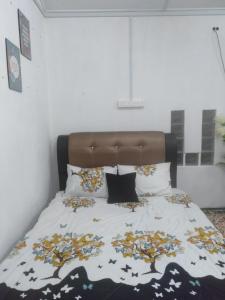 Pasir Mas的住宿－Layya Homestay，床上有毯子,有枕头