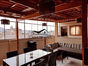 a restaurant with a table and chairs and a large window at Hostal Casa de Ana in Nazca