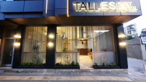 a store front of a building with a sign on it at TALLES CITY HOTEL in Konak