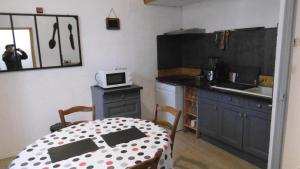 a kitchen with a table with a polka dot table cloth at Appartement LE COURS in Barbentane