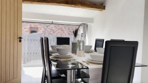a dining room with a glass table and chairs at Beautiful country retreat for 6, with free parking in Carlisle