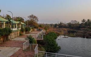 a bridge over a body of water next to a river at Wandr Zen in Khopoli