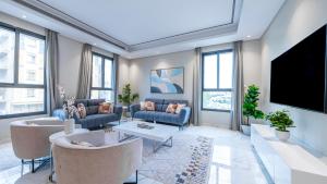 a living room with couches and a flat screen tv at Mabaat-Lilium Al Salama 513 in Jeddah