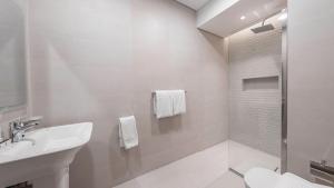 a white bathroom with a sink and a shower at Mabaat-Lilium Al Salama 513 in Jeddah +52 photos