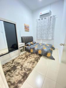 a room with two beds and a television in it at SARASERA HOMESTAY with PRIVATE POOL MELAKA in Malacca +15 photos