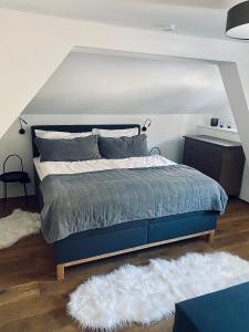 a bedroom with a blue bed and a white rug at Chalet Badberg in Bad Gastein