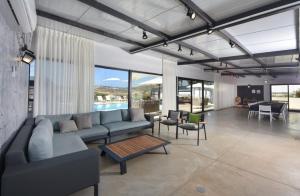 a living room with a couch and a table at מטע וכרם in Elqosh