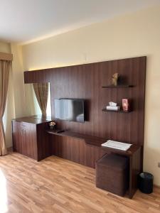 a hotel room with a desk and a television at Weekdays Hotel in Muscat