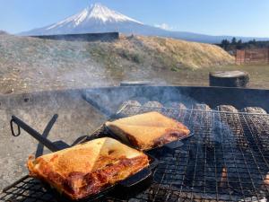 a grill with two pieces of food on it at MT. FUJI SATOYAMA VACATION in Fujinomiya