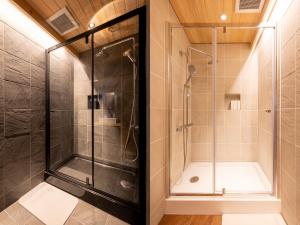 a shower in a bathroom with a glass shower stall at MT. FUJI SATOYAMA VACATION in Fujinomiya