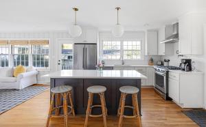 a kitchen with a large island with two bar stools at * Affordable Luxury Park Circle, Tres Chic! * in Charleston