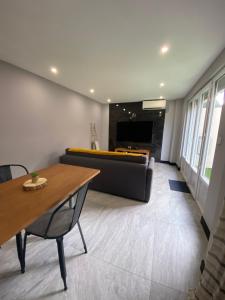 a living room with a couch and a table at Studio standing bord de mer in Mandelieu-La Napoule