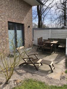 a patio with two chairs and a table and a bench at Ferienwohnung Völker in Häven
