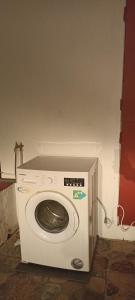 a white washing machine sitting in a room at L'étonnant F3 Joris in Saint-Pierre