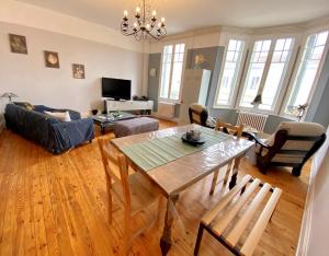 un salon avec une table et un canapé dans l'établissement LE VIKING DOUILLET - Proche Thermes & Parcs - Parking à 50m, à Vichy