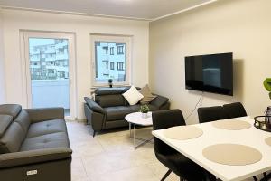 a living room with a couch and a table at Apartment Wesseling in Wesseling