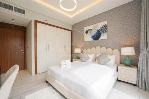 a bedroom with a large white bed in a room at KeyHost - Regent Court JVC - K420 in Dubai