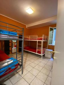 a room with three bunk beds in a room at Emerald Fields Hostel in Florence