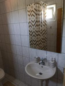 a bathroom with a sink and a mirror at Apartment in Lopar with sea view, terrace, washing machine, dishwasher 593-1 in Lopar +43 photos