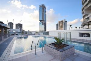 a swimming pool on the roof of a building at KeyHost - Regent Court JVC - K420 in Dubai