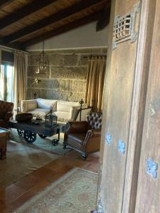 a living room with a couch and a coffee table at Casa do Ouro in Aldán