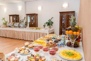 a buffet of food on a table in a room at Hotel Artur in Kraków
