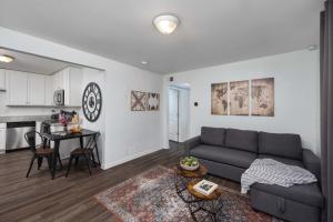 a living room with a couch and a table at The Vibe at Marathon Apartment Suites in Nashville