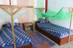 two bunk beds in a room with at CDAC Elijah - Espace Culturel in Ouidah