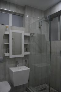 a bathroom with a sink and a glass shower at Accommodation Front - Luxurious 2 Sleeper Overlooking the Beachfront in Durban