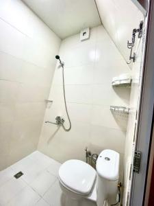 a bathroom with a toilet and a shower at N STORY in Keda