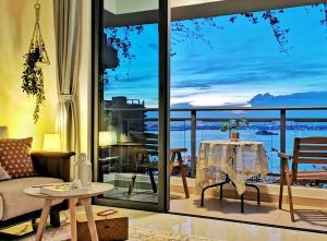 a living room with a view of the ocean at Yussy Homestay at Regalia Park Forest City in Gelang Patah