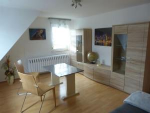 a living room with a glass table and chairs at Ferienhaus auf dem Gries 17 in Schmalkalden