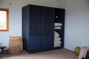 a blue cabinet with towels in a room at WORM in Awaji