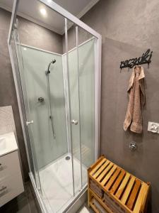 a shower with a glass door in a bathroom at Apartament Arverso in Bolesławiec +16 photos