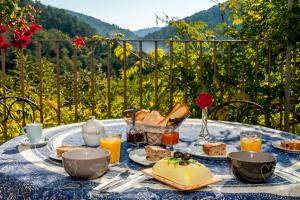a table with a blue table cloth with food on it at Le mas des sources cevenol Le chambon in Le Chambon