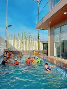 a group of people in a swimming pool at Ri Rot villa - Venuestay in Quy Nhon