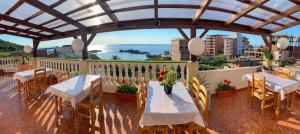 a balcony with tables and chairs and a view of the ocean at Hotel plage d'or in Jijel